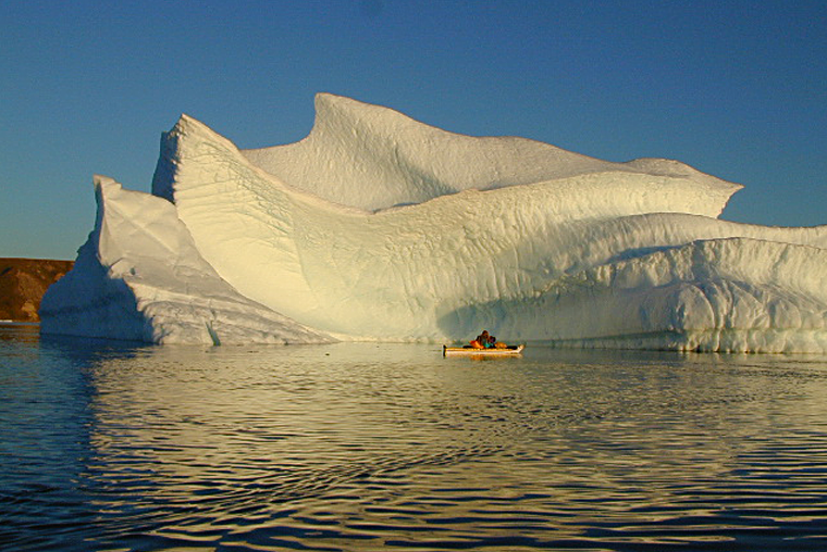 Ice berg, person in kayak, Pond Inlet, Bylot Island, Nunavut.