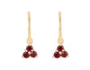 Pair of yellow gold studs in the shape of a bunch of grapes carved in detail in relief. Hanging from the bottom are trios of round red rubies forming a triangle.