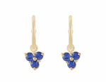 Trio of blue sapphire drops hung on yellow gold hoops.
