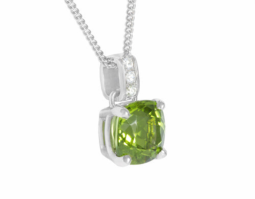 Natural apple-green peridot pendant in platinum with diamond accents.