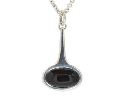 Very large silver pendant with black onyx.  Hung on silver chain.
