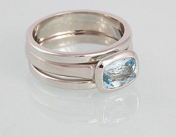 White gold ring with rectangle blue aquamarine, matching white gold bands.