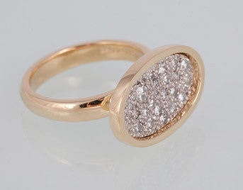 Yellow gold ring with scattering of diamonds in oval face.