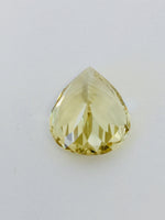 Large pear shaped light yellow chrysoberyl gem, on white background.