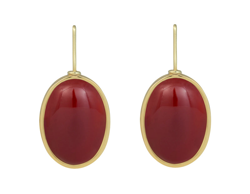 Large oval deep red carnelian cabochons in green gold frame and shepherd's hooks.