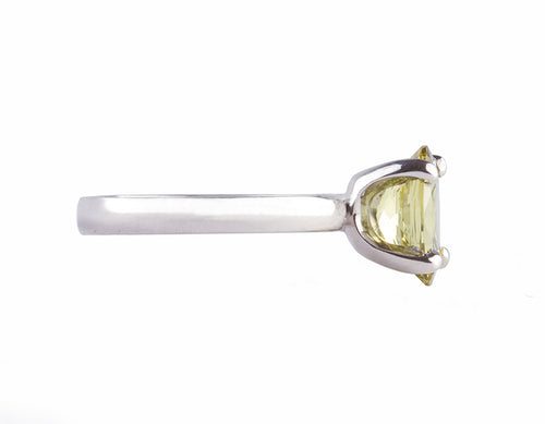 Platinum ring set with an oval chrysoberyl. The gem shows flashes of yellows, greens, browns etc. The gem is prong set and sits above the band.