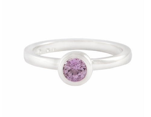 Thin platinum ring set with round pink spinel.  the gem is set in a frame and sits above the band.