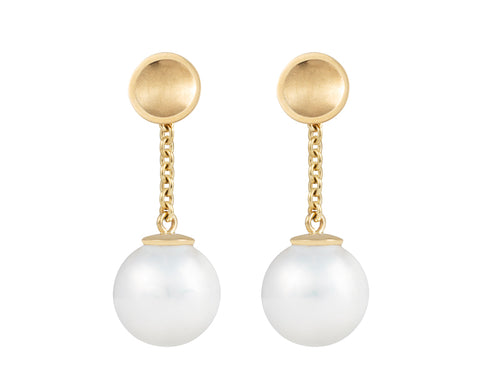 Large white pearls with yellow gold cap and chain dangling from yellow gold stud.