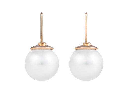 Large white pearls with rose gold caps on rose gold shepherd's hooks.