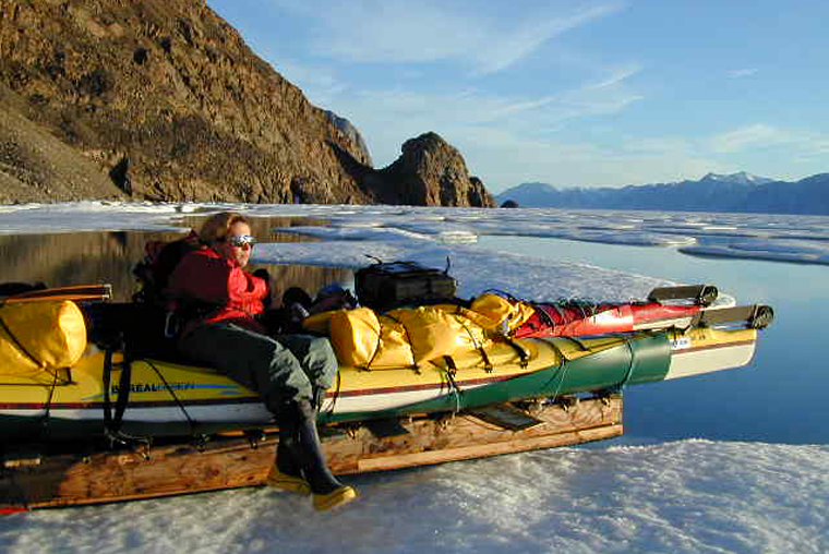Kayak and komatik on sea ice with Pamela Coulston, Pond Inlet, Nunavut.