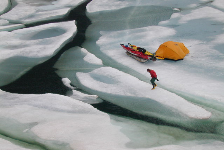 Kayak and tent on sea ice, Pond Inlet, Nunavut.