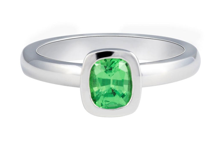 Medium size green gem in platinum ring.