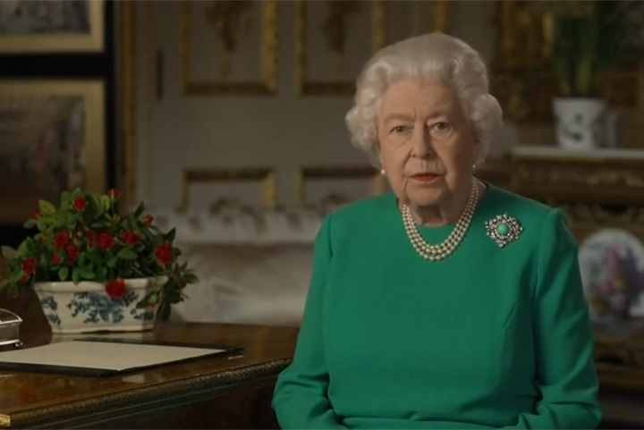 Queen wearing green dress and brooch