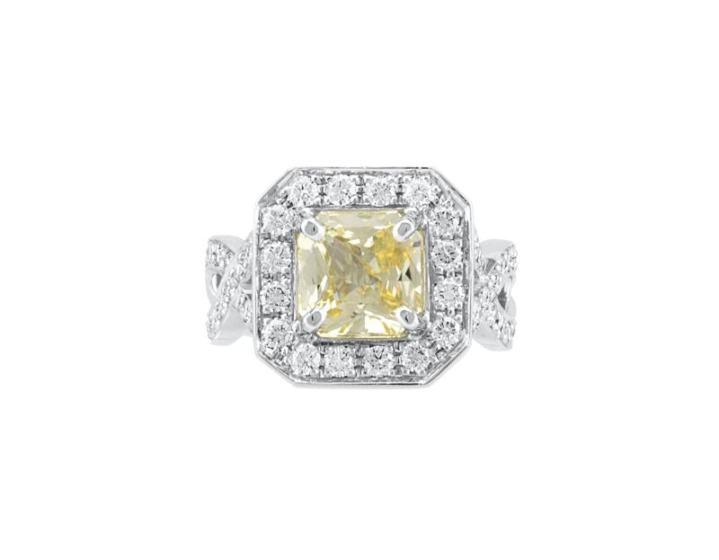 Large yellow sapphire in platinum ring with diamonds.