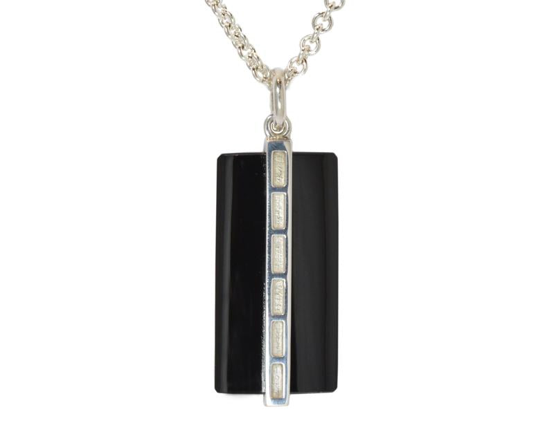 Silver pendant, black onyx wafer, on silver chain.