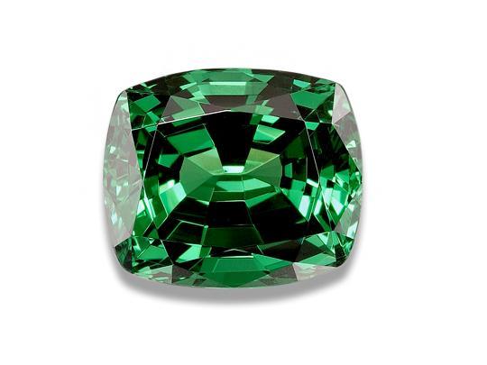 Green tsavorite garnet gem, white background.