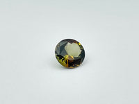 Caramel, brown, green Andalusite gem, round.