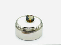 Caramel, brown, green Andalusite gem, round. 