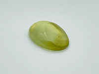 Green beryl cabochon with one large facet.