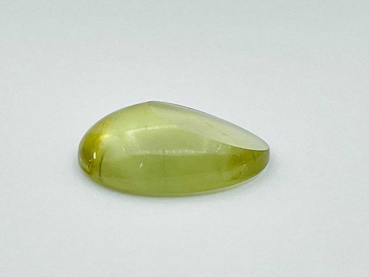 Green beryl cabochon with one large facet.