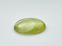 Green beryl cabochon with one large facet.