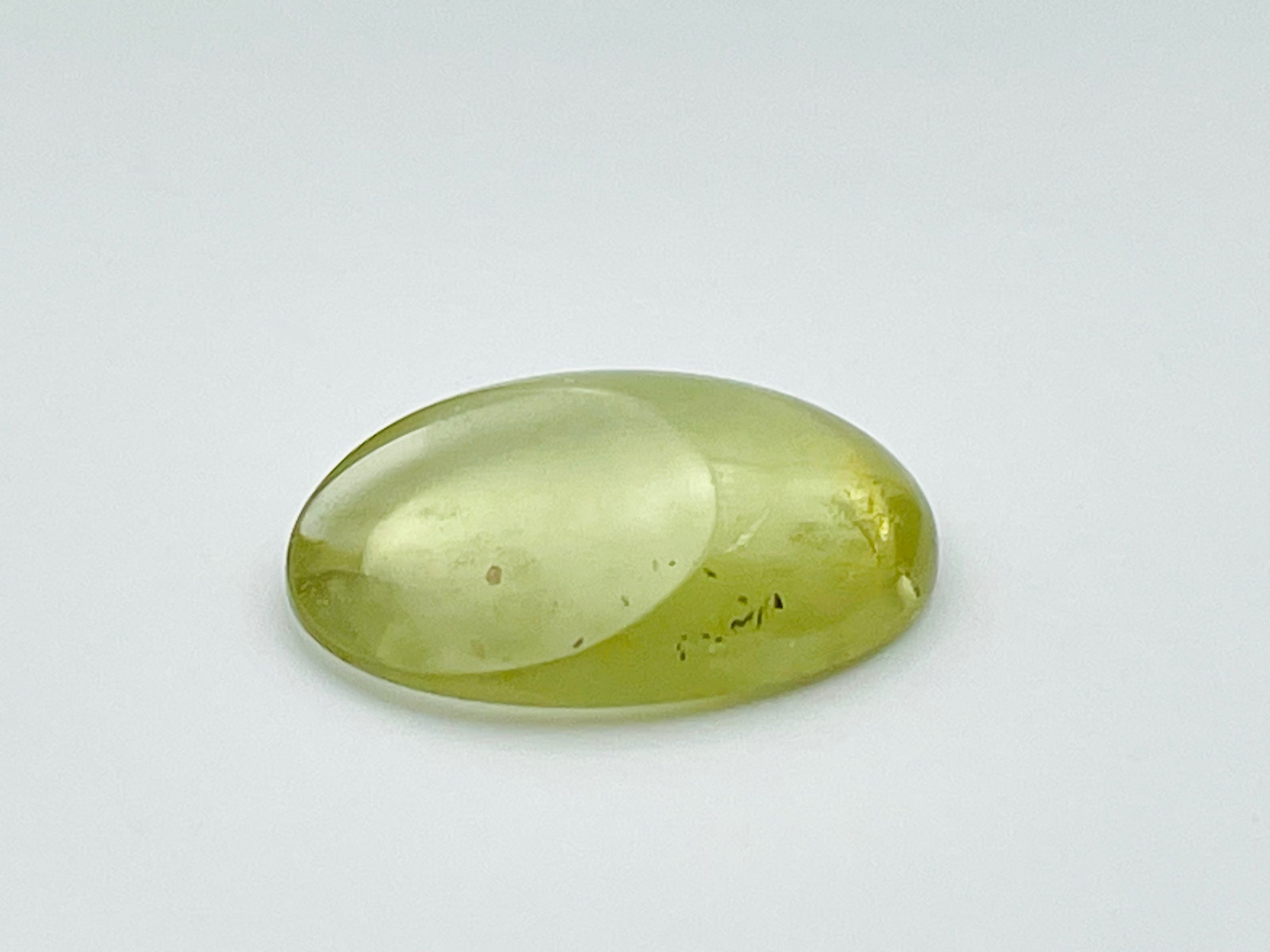Green beryl cabochon with one large facet.