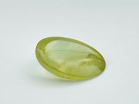 Green beryl cabochon with one large facet.