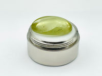 Green beryl cabochon with one large facet.