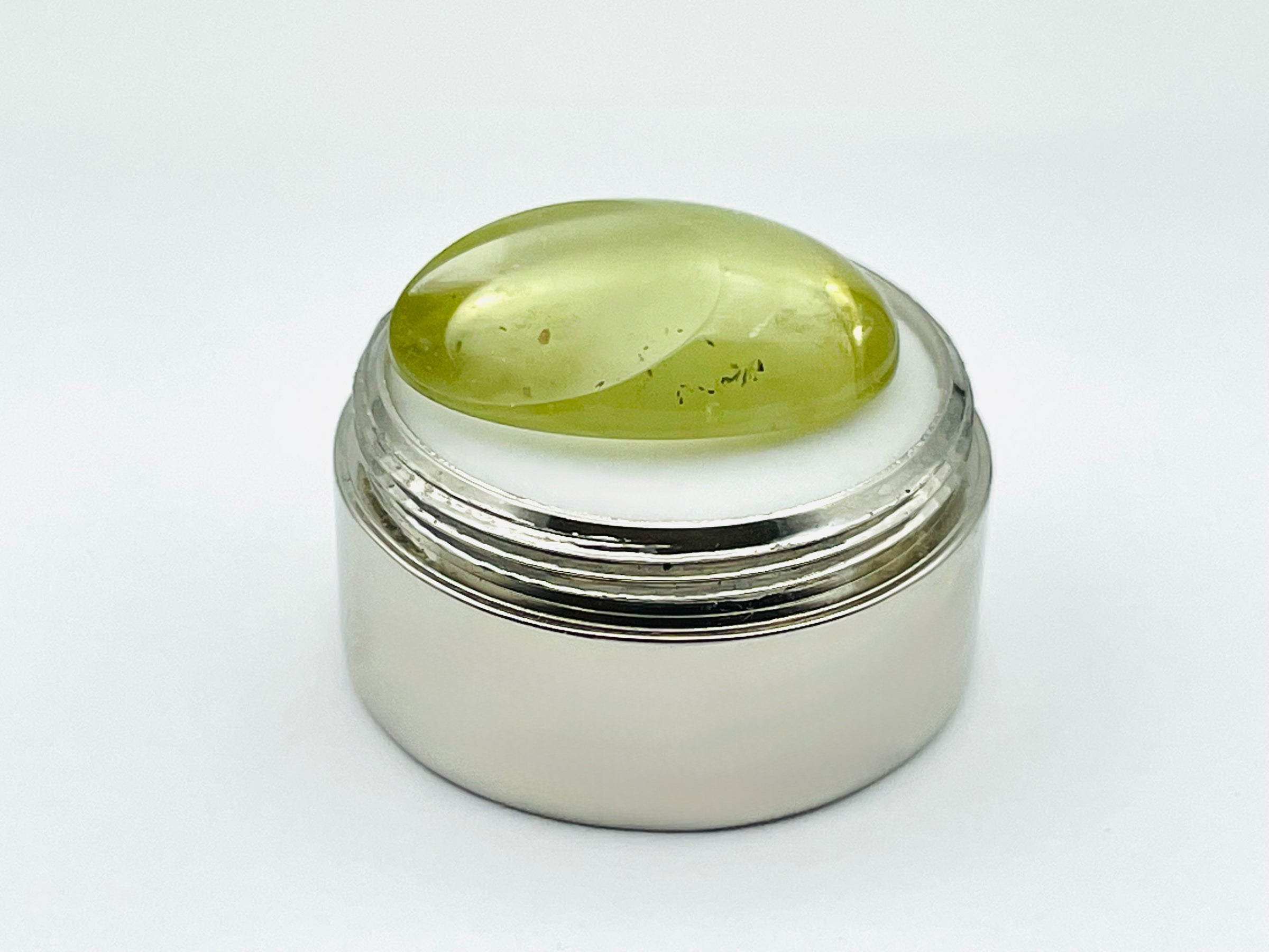 Green beryl cabochon with one large facet.
