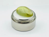 Green beryl cabochon with one large facet.