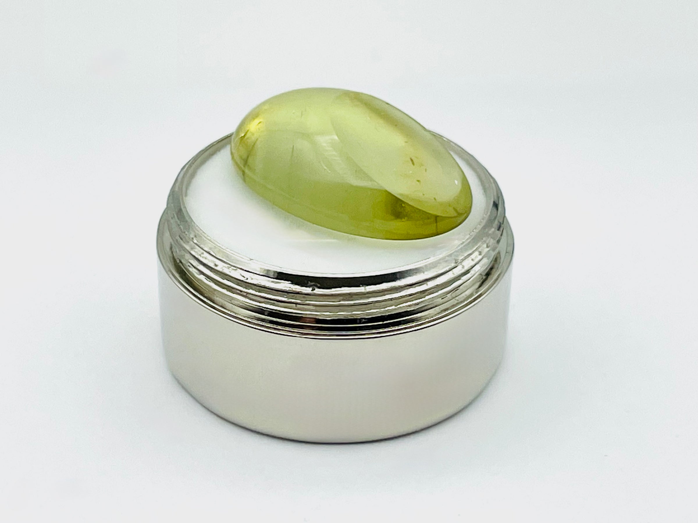Green beryl cabochon with one large facet.
