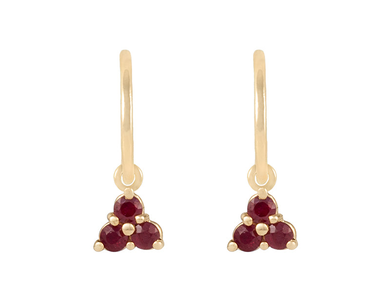 Pair of yellow gold studs in the shape of a bunch of grapes carved in detail in relief. Hanging from the bottom are trios of round red rubies forming a triangle.