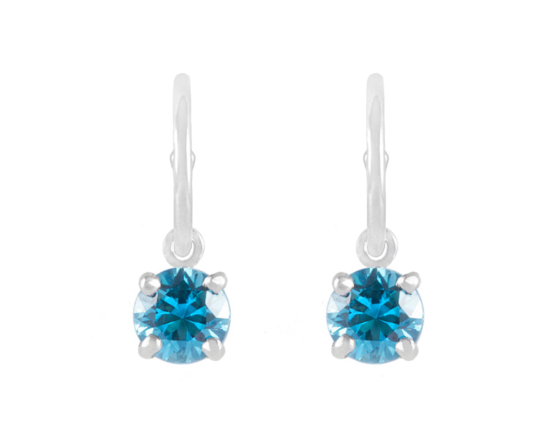 Natural blue zircon drops on platinum hoops.