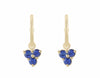 Trio of blue sapphire drops hung on yellow gold hoops.