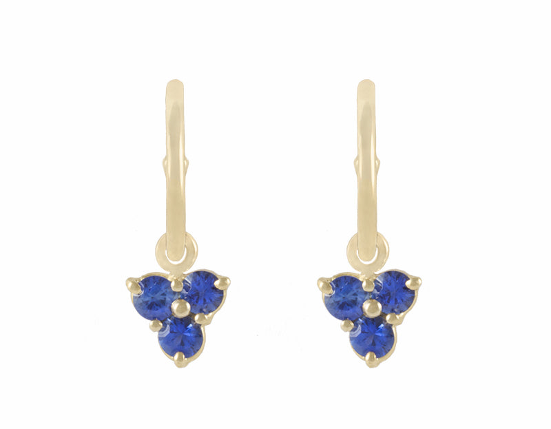 Trio of blue sapphire drops hung on yellow gold hoops.