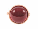 Large round cabochon of hessonite garnet in solid 18k rose gold ring.