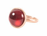 Large round cabochon of hessonite garnet in solid 18k rose gold ring.