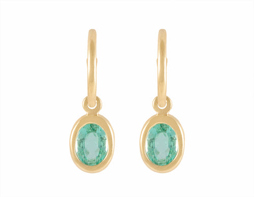 18k green gold hoops with oval light coloured emeralds