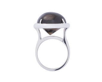 Large silver ring with oval brown gem.