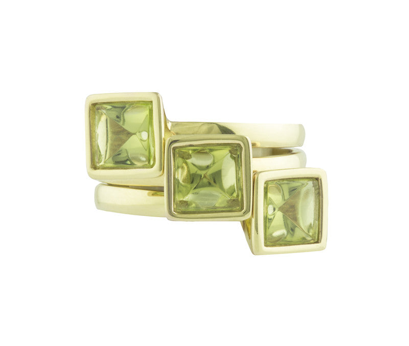 Three green gold rings set with square green peridot gems.