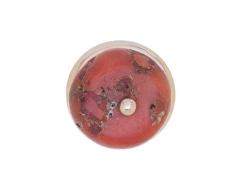 Large orange coral bead in rose gold ring.