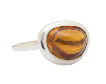 Large silver ring with oval orange gem