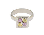 White gold ring with pedestal to square face set with pink and yellow sapphire.