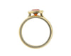 Deep orange round gem in green gold ring and matching green gold bands.
