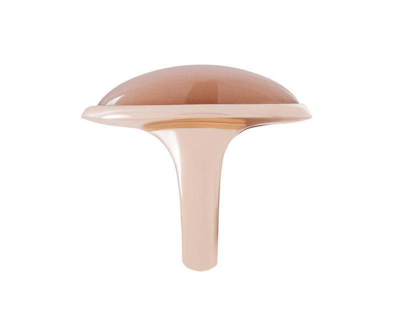 Very long cabochon of salmon pink moonstone coming to point at both ends, set in frame of rose gold.