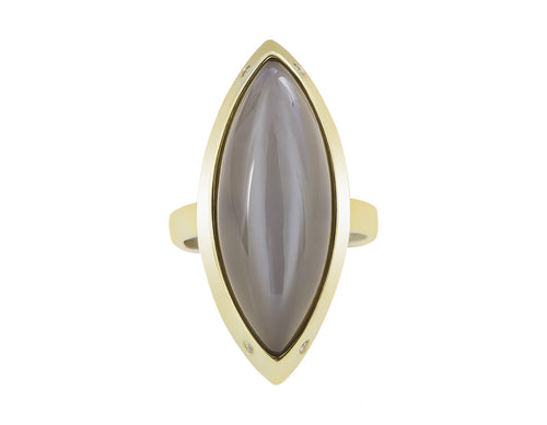 Very long cabochon of grey moonstone coming to point at both ends, set in frame of green gold with four accent diamonds in frame.