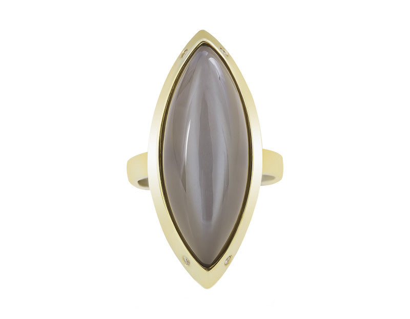 Very long cabochon of grey moonstone coming to point at both ends, set in frame of green gold with four accent diamonds in frame.