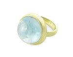 Very large green gold ring set with large round cabochon of blue aquamarine. Gem is set in frame and goes just beyond width of finger.