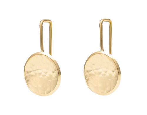 Round drop earrings in yellow gold with hammered texture in bowl on shepherd's hooks.