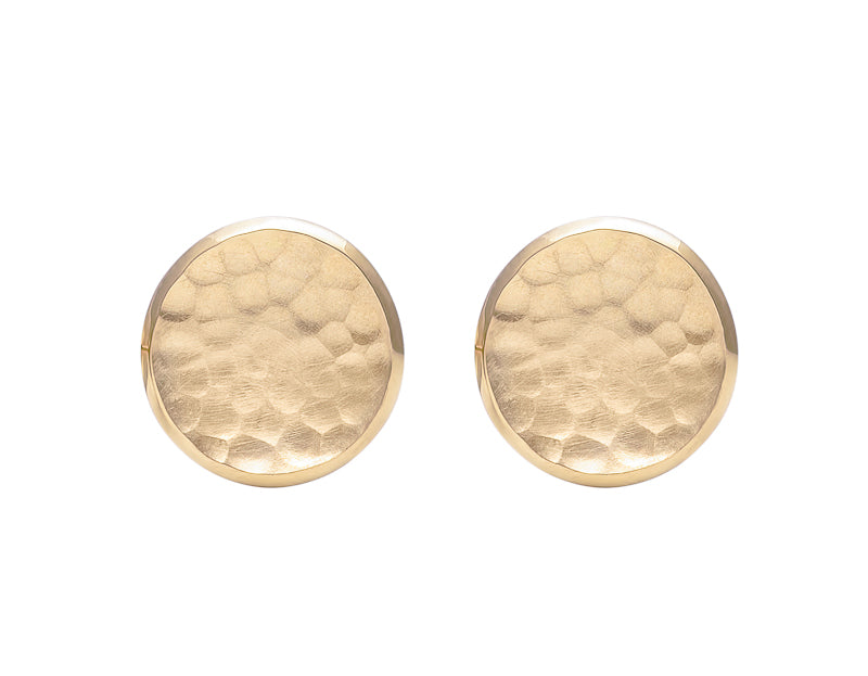 Round stud earrings in yellow gold with hammered texture in bowl.